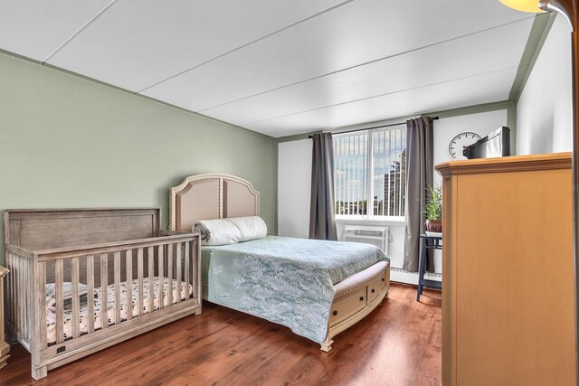 225 S Rohlwing Rd Unit 301, Palatine, IL 60074 - bedroom featuring wood finished floors and a wall mounted air conditioner