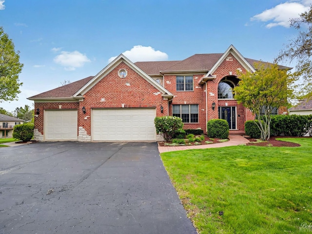 1321 Oak Hill Ln, Hampshire, IL 60140 - view of front of property featuring a front yard, driveway, an attached garage, and brick siding