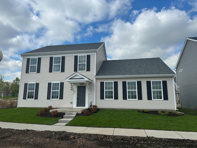 995 Celebration Dr, Aurora, IL 60504 - colonial-style house with a front lawn and roof with shingles