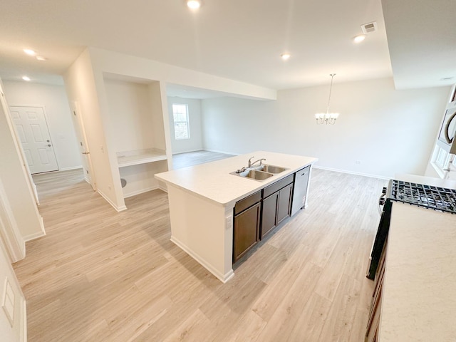 995 Celebration Dr, Aurora, IL 60504 - kitchen featuring a sink, light countertops, light wood-style flooring, a chandelier, and recessed lighting