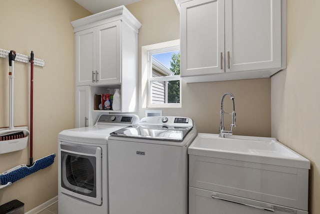 laundry area featuring separate washer and dryer and cabinet space