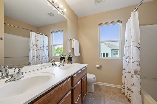 full bathroom featuring toilet, baseboards, tile patterned flooring, and double vanity