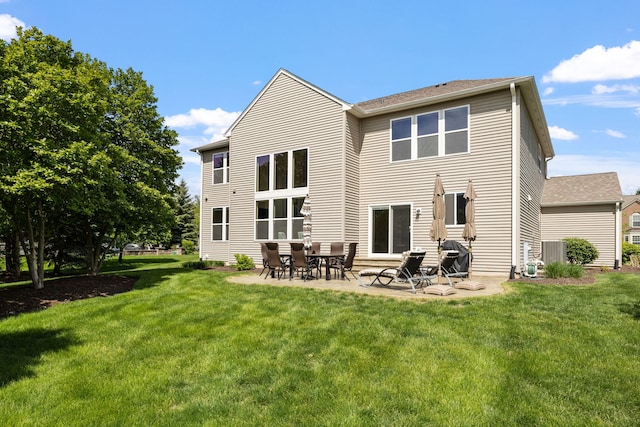 back of house featuring a yard and a patio area