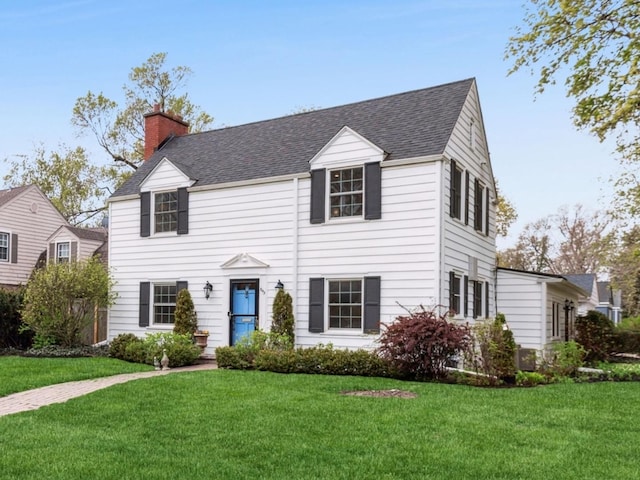 843 Chilton Ln, Wilmette, IL 60091 - view of front of home featuring a chimney, a front yard, and roof with shingles