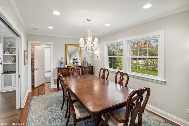 dining area featuring a chandelier, recessed lighting, baseboards, and crown molding