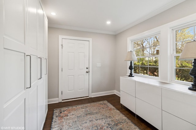 foyer entrance featuring baseboards, dark wood-type flooring, crown molding, and recessed lighting