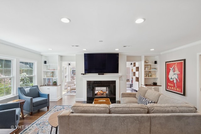 843 Chilton Ln, Wilmette, IL 60091 - living room featuring built in shelves, crown molding, dark wood finished floors, recessed lighting, and a multi sided fireplace