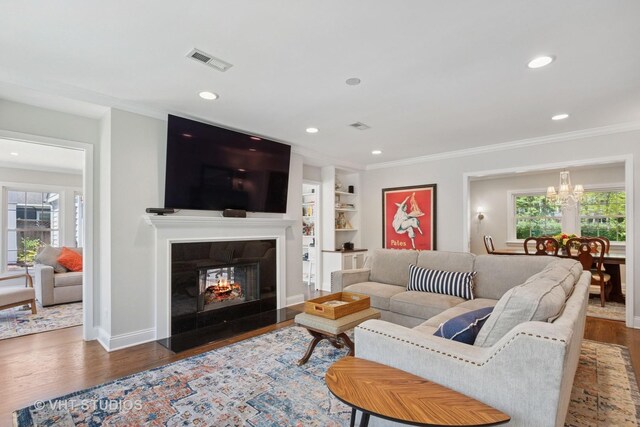 843 Chilton Ln, Wilmette, IL 60091 - living area featuring plenty of natural light, ornamental molding, wood finished floors, a chandelier, and recessed lighting