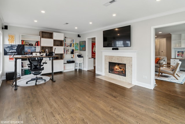 office with recessed lighting, ornamental molding, a fireplace with flush hearth, wood finished floors, and baseboards