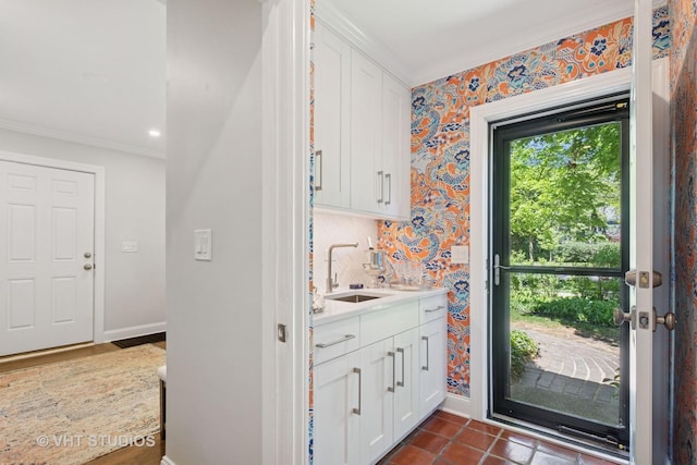 843 Chilton Ln, Wilmette, IL 60091 - kitchen featuring a sink, crown molding, white cabinets, light countertops, and baseboards