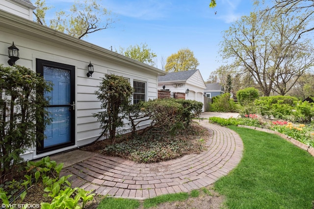view of home's exterior featuring a garage and a lawn