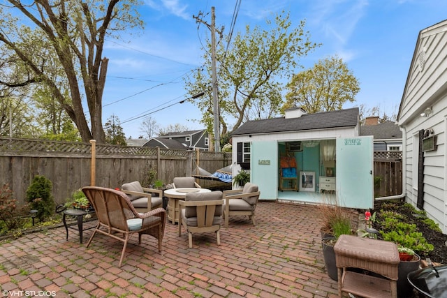 view of patio / terrace with a fenced backyard and an outdoor structure