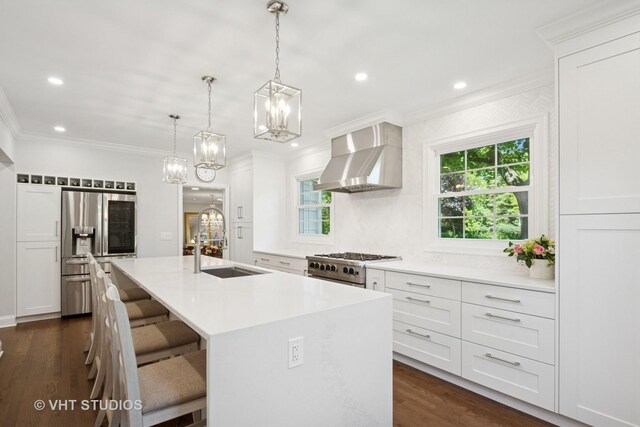 843 Chilton Ln, Wilmette, IL 60091 - kitchen with stainless steel appliances, a sink, a chandelier, wall chimney exhaust hood, and ornamental molding