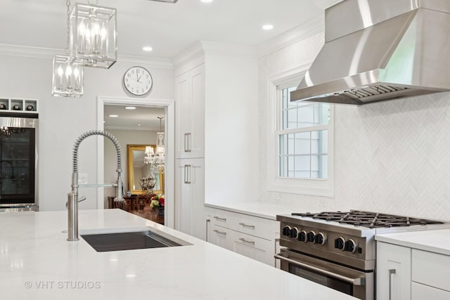843 Chilton Ln, Wilmette, IL 60091 - kitchen with wall chimney exhaust hood, stainless steel stove, a sink, light countertops, and crown molding