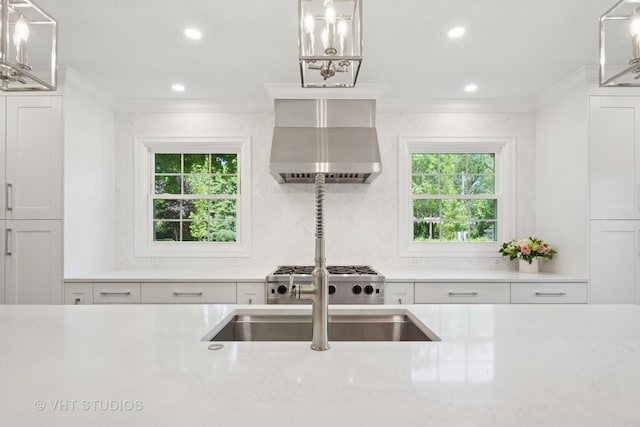 843 Chilton Ln, Wilmette, IL 60091 - kitchen featuring wall chimney range hood, crown molding, white cabinets, stove, and light stone counters
