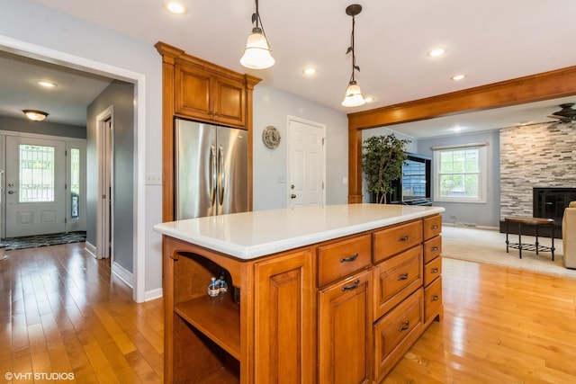 kitchen with stainless steel fridge, baseboards, light wood-style floors, open floor plan, and recessed lighting