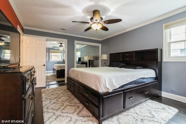 bedroom with wood finished floors, baseboards, crown molding, and ceiling fan