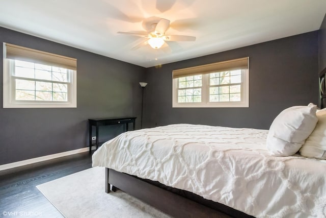 bedroom with wood finished floors, baseboards, and a ceiling fan