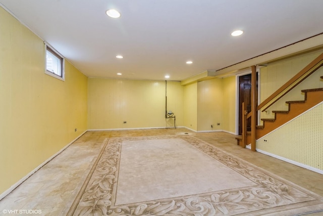 below grade area featuring baseboards, recessed lighting, and stairway