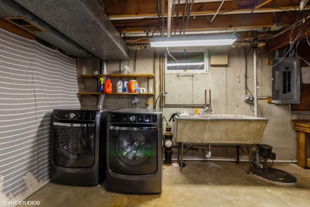 laundry room featuring electric panel and washer and dryer