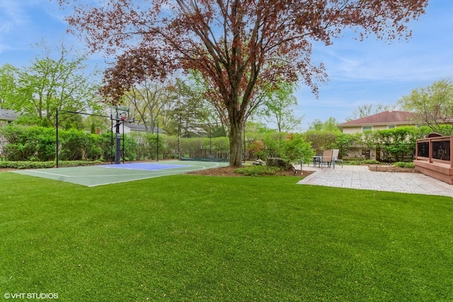 view of yard featuring basketball hoop