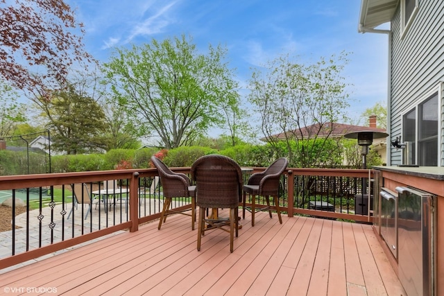 wooden deck featuring beverage cooler
