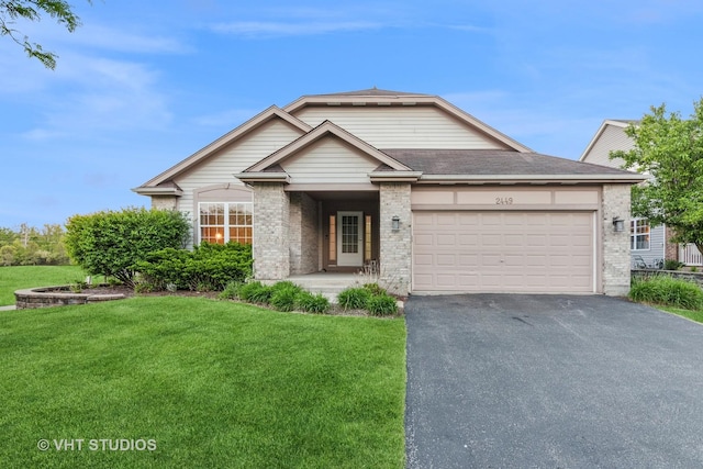 ranch-style home with asphalt driveway, a front yard, a garage, and brick siding