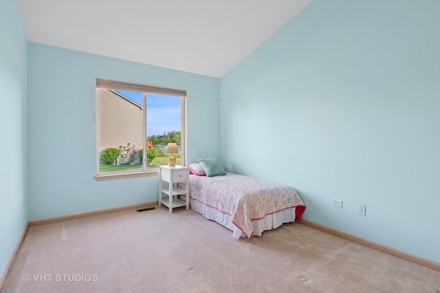 bedroom featuring carpet floors, baseboards, and lofted ceiling