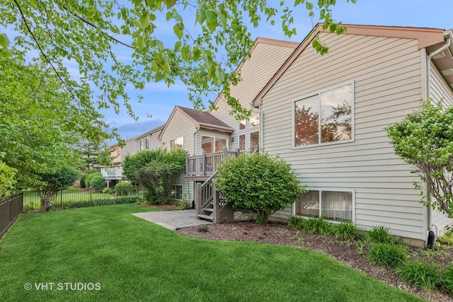 rear view of property with a wooden deck