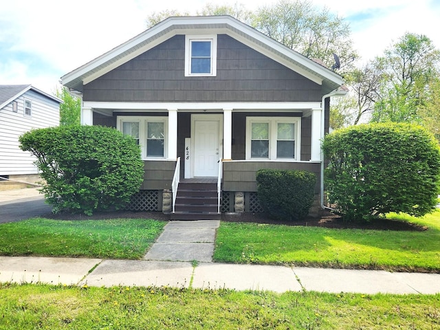 view of front of home featuring covered porch and a front lawn