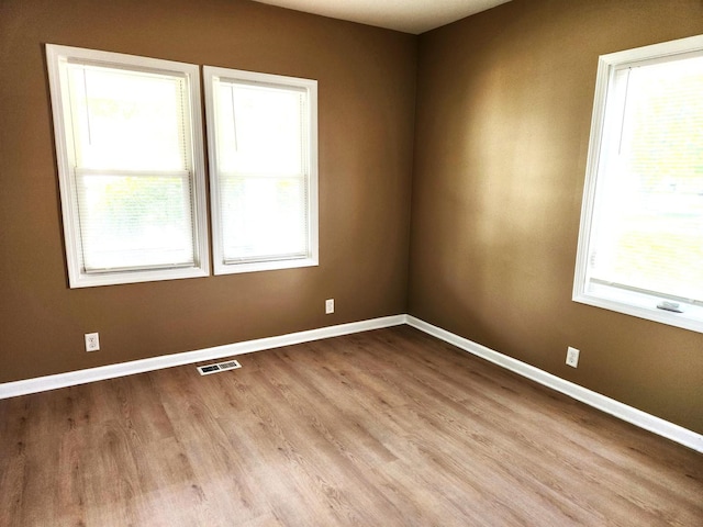 empty room with wood finished floors and baseboards