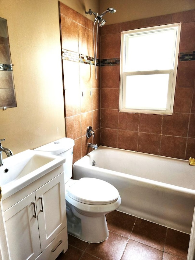 bathroom with shower / tub combination, toilet, vanity, and tile patterned floors