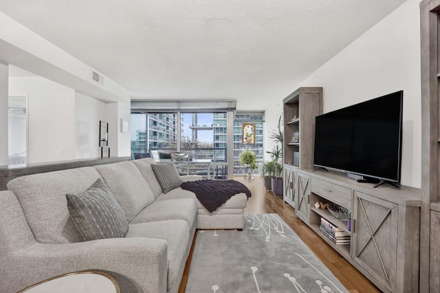9725 Woods Dr Unit 507, Skokie, IL 60077 - living room with expansive windows, light wood-style flooring, and a textured ceiling