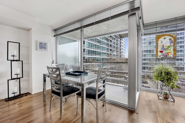 9725 Woods Dr Unit 507, Skokie, IL 60077 - dining area with wood finished floors, expansive windows, and baseboards