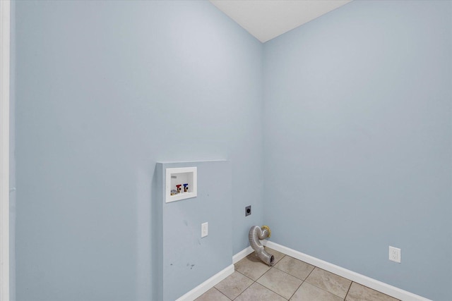 laundry room featuring electric dryer hookup, washer hookup, light tile patterned floors, and baseboards