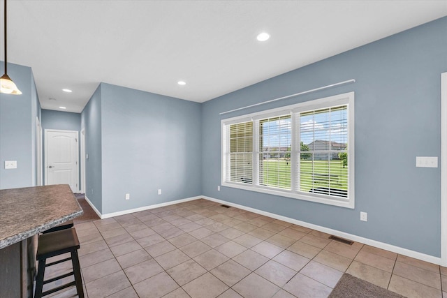 spare room with tile patterned floors, baseboards, and recessed lighting