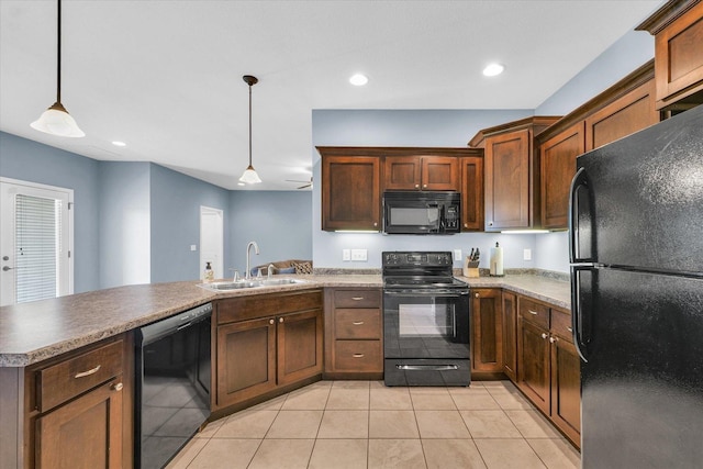 kitchen featuring black appliances, a sink, a peninsula, light tile patterned floors, and decorative light fixtures
