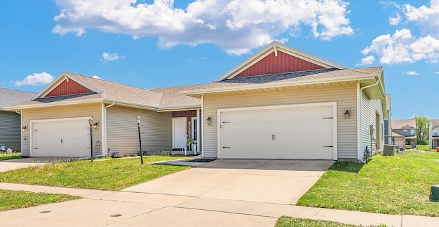view of front of home featuring a front yard, a garage, driveway, a shingled roof, and board and batten siding