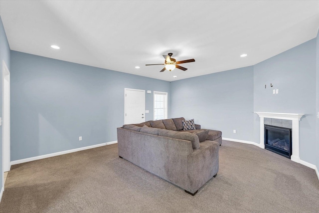 living room with a ceiling fan, carpet, a tile fireplace, baseboards, and recessed lighting