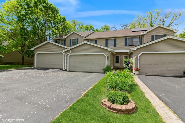 213 Pamela Dr, Bolingbrook, IL 60440 - townhome / multi-family property with a garage, solar panels, and asphalt driveway