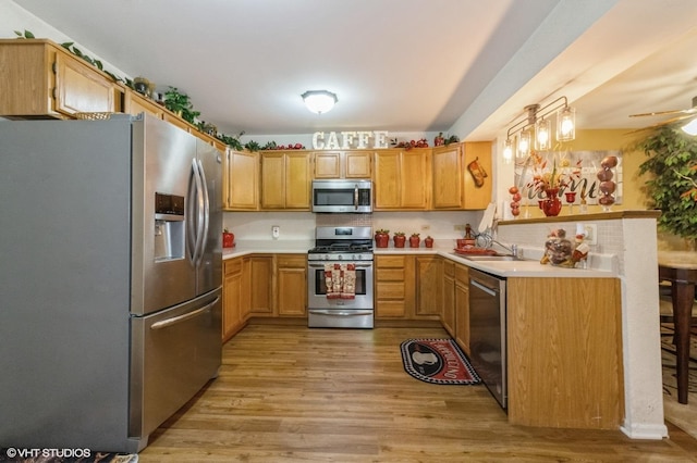 213 Pamela Dr, Bolingbrook, IL 60440 - kitchen featuring stainless steel appliances, light wood-style floors, light countertops, and a ceiling fan