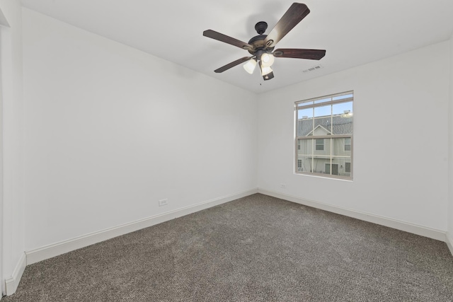spare room with carpet floors, baseboards, and a ceiling fan