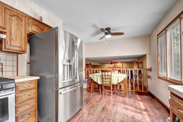6732 W 113th Pl, Worth, IL 60482 - kitchen featuring appliances with stainless steel finishes, a ceiling fan, wood finished floors, light countertops, and brown cabinets