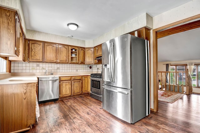 6732 W 113th Pl, Worth, IL 60482 - kitchen featuring appliances with stainless steel finishes, brown cabinetry, dark wood-type flooring, and light countertops