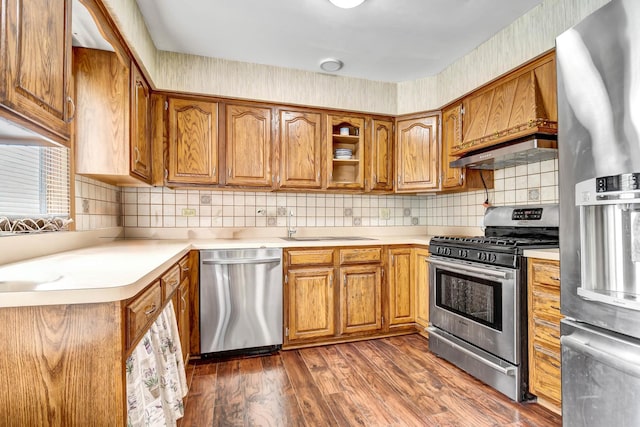 6732 W 113th Pl, Worth, IL 60482 - kitchen featuring stainless steel appliances, brown cabinetry, dark wood-style floors, and light countertops