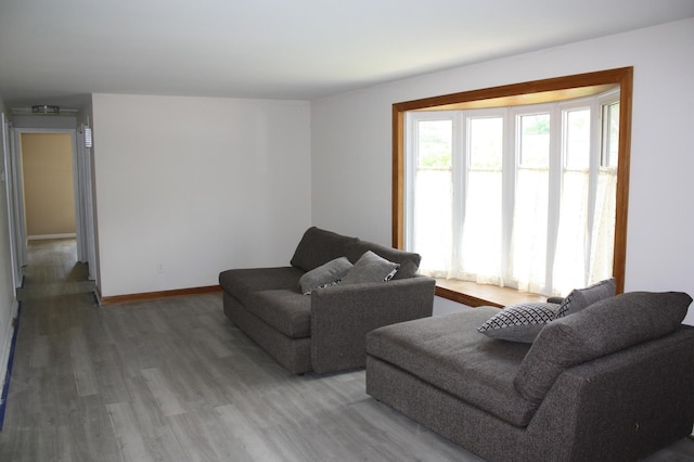 living area with wood finished floors and baseboards