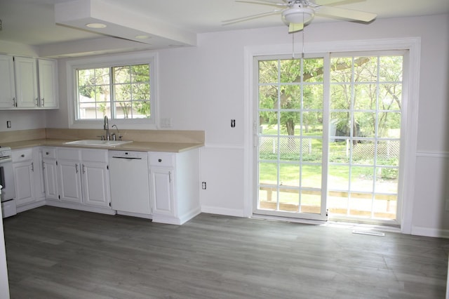 kitchen with white appliances, a sink, a ceiling fan, white cabinetry, and wood finished floors