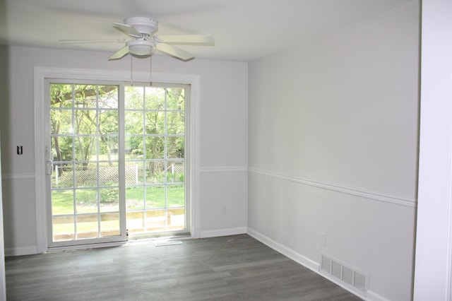 unfurnished room with a ceiling fan, baseboards, and wood finished floors