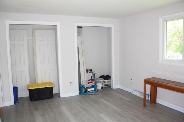 bedroom featuring wood finished floors and baseboards