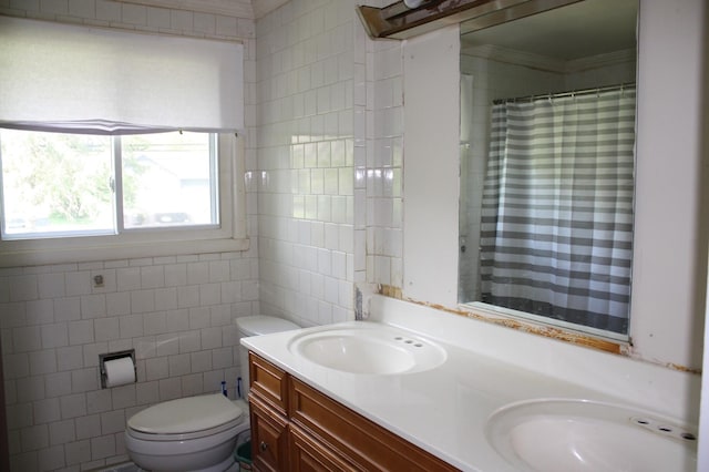 bathroom featuring toilet, double vanity, tile walls, crown molding, and curtained shower